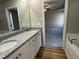Bathroom featuring a double vanity with granite countertop and access to main bedroom at 343 Magnolia Run Way, Benson, NC 27504