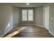 Bright bedroom featuring new laminate flooring, neutral walls, and natural light from the double windows at 343 Magnolia Run Way, Benson, NC 27504