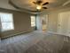 Main bedroom featuring trey ceiling with fan, carpet floors, and ensuite bathroom at 343 Magnolia Run Way, Benson, NC 27504