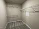 Walk-in closet featuring carpeted floor and adjustable metal shelving for optimal storage at 343 Magnolia Run Way, Benson, NC 27504