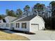 View of the home with attached garage, white siding, black shutters, and concrete driveway at 343 Magnolia Run Way, Benson, NC 27504