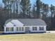 Charming single-story home with white siding, black shutters, and a well-manicured lawn at 343 Magnolia Run Way, Benson, NC 27504