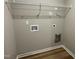 The laundry room with shelving, wood look flooring, and connections for your washer and dryer at 343 Magnolia Run Way, Benson, NC 27504
