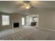 Spacious living room featuring a fireplace, ceiling fan, and access to kitchen at 343 Magnolia Run Way, Benson, NC 27504