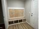 Functional mudroom with built-in bench, storage cubbies, and laminate flooring at 343 Magnolia Run Way, Benson, NC 27504