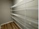 Walk-in pantry featuring sturdy wire shelving and laminate wood flooring at 343 Magnolia Run Way, Benson, NC 27504
