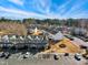 Aerial view of the townhome community with manicured grounds and ample parking, set against a backdrop of sparse trees at 3931 Volkswalk Pl, Raleigh, NC 27610
