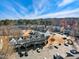 Overhead shot of inviting townhomes and designated parking spaces, surrounded by bare trees, and clear, blue skies at 3931 Volkswalk Pl, Raleigh, NC 27610