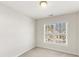 Bright bedroom with neutral walls and carpet, offering a view of the neighborhood at 3931 Volkswalk Pl, Raleigh, NC 27610