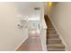 Bright entryway featuring wood floors, stairs with carpeted steps and white risers, open to a spacious living area at 3931 Volkswalk Pl, Raleigh, NC 27610