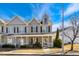 Charming townhome featuring a covered front porch, neutral siding, and black shutters, set against a bright blue sky at 3931 Volkswalk Pl, Raleigh, NC 27610