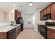 Well-appointed kitchen featuring wood cabinets, granite countertops, stainless steel appliances, and modern fixtures at 3931 Volkswalk Pl, Raleigh, NC 27610