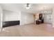 Spacious living room with wood flooring, custom built-in cabinetry, and an open layout leading to the kitchen at 3931 Volkswalk Pl, Raleigh, NC 27610
