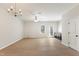 Spacious living room featuring wood flooring, ceiling fan, chandelier, and custom built-in cabinetry at 3931 Volkswalk Pl, Raleigh, NC 27610