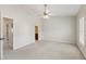 Serene main bedroom with ceiling fan, carpet, and en-suite bathroom access at 3931 Volkswalk Pl, Raleigh, NC 27610