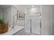 Modern bathroom featuring a glass-enclosed shower, gray vanity, framed art, and stylish fixtures at 415 Swift Creek Farm Ln, Clayton, NC 27520