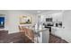 Open concept kitchen featuring granite countertops, white cabinetry, stainless steel appliances, and wicker barstools at 415 Swift Creek Farm Ln, Clayton, NC 27520