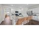 Bright kitchen with white cabinets, granite countertops, stainless steel appliances, and wicker barstools at 415 Swift Creek Farm Ln, Clayton, NC 27520