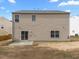 The backyard features a large lawn, a small patio, and the siding of the home at 4207 Hampstead Village Dr, Durham, NC 27703