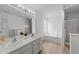 Bright bathroom with double sink vanity, bathtub, and wood look floors at 4207 Hampstead Village Dr, Durham, NC 27703