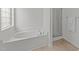 Bathroom with large bathtub and clear glass shower at 4207 Hampstead Village Dr, Durham, NC 27703