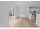 Light-filled dining area showcases modern lighting and sliding doors, seamlessly connecting indoor and outdoor spaces at 4207 Hampstead Village Dr, Durham, NC 27703