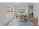 Elegant dining room with natural light, chandelier, and a view of the backyard on luxury vinyl flooring at 4207 Hampstead Village Dr, Durham, NC 27703