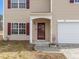 Home exterior with a well-manicured lawn and a covered front entrance at 4207 Hampstead Village Dr, Durham, NC 27703