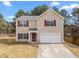 Two-story home with a front lawn, two car garage and red shutters at 4207 Hampstead Village Dr, Durham, NC 27703