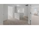 Bright, carpeted hallway with white walls and doorways at 4207 Hampstead Village Dr, Durham, NC 27703