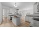Bright kitchen features granite countertops, stainless steel appliances, and a central island offering ample workspace at 4207 Hampstead Village Dr, Durham, NC 27703