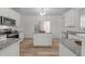 Kitchen featuring an island with granite countertops, stainless steel appliances, and ample cabinet space at 4207 Hampstead Village Dr, Durham, NC 27703