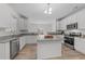 Modern kitchen featuring granite countertops, stainless steel appliances, island, and ample cabinet space at 4207 Hampstead Village Dr, Durham, NC 27703