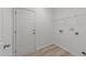 Functional laundry room featuring utility connections and a storage shelf for convenience at 4207 Hampstead Village Dr, Durham, NC 27703