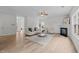 Bright living room features a fireplace, ceiling fan, and wood flooring, providing a warm and inviting atmosphere at 4207 Hampstead Village Dr, Durham, NC 27703