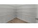 Spacious walk-in closet with multiple levels of shelving providing ample storage at 4207 Hampstead Village Dr, Durham, NC 27703