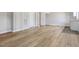 Spacious basement featuring wood-look flooring, new paint, and a utility sink at 427 Watson Rd, Efland, NC 27243