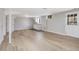 Finished basement has wood-look floors, white walls, sink, and door to the exterior at 427 Watson Rd, Efland, NC 27243