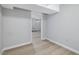 Hallway in the basement with laminate floors and neutral paint, leading to other rooms at 427 Watson Rd, Efland, NC 27243