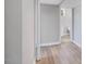Basement hallway with access to a bathroom, laminate flooring, and a neutral color palette at 427 Watson Rd, Efland, NC 27243