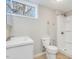 Basement bathroom featuring a walk-in shower, single sink vanity, and ample lighting at 427 Watson Rd, Efland, NC 27243