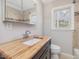 Bathroom features a modern vanity with stylish fixtures and natural light from a window at 427 Watson Rd, Efland, NC 27243