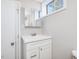 Bright bathroom features a white vanity, a mirror, and a window for natural light at 427 Watson Rd, Efland, NC 27243