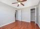 Bedroom features wood floors, a ceiling fan, and a closet at 427 Watson Rd, Efland, NC 27243