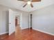 Bedroom with hardwood flooring, closet, and doorway view to front of home at 427 Watson Rd, Efland, NC 27243