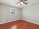 Bedroom features hardwood floors, a ceiling fan and natural light from window at 427 Watson Rd, Efland, NC 27243