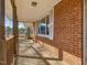 Detailed view of the brick siding and covered front porch with white trim at 427 Watson Rd, Efland, NC 27243