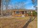 Charming single-story brick home featuring a covered carport, covered front porch, and a well-maintained lawn at 427 Watson Rd, Efland, NC 27243