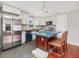 Well-lit kitchen featuring an island with seating and stainless steel appliances at 427 Watson Rd, Efland, NC 27243