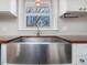 Large farmhouse style sink with stainless faucet beneath a window at 427 Watson Rd, Efland, NC 27243